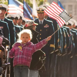 Thank you for your service! Image of U.S. Coast Guard families and service members in New York City Veterans Day Parade, also used for Memorial Day 2024 blog post